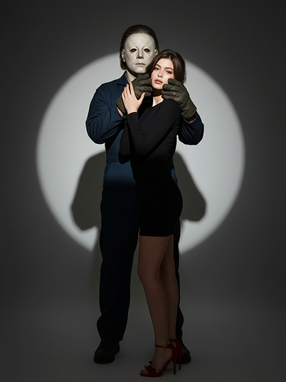 a girl standing in the spotlight with Michael Myers
