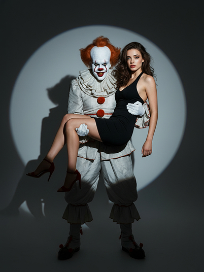 a girl standing in the spotlight with a clown